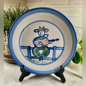 M.A. HADLEY POTTERY, 11” DINNER PLATE WITH HAND-PAINTED FARMER PLAYING A GUITAR.